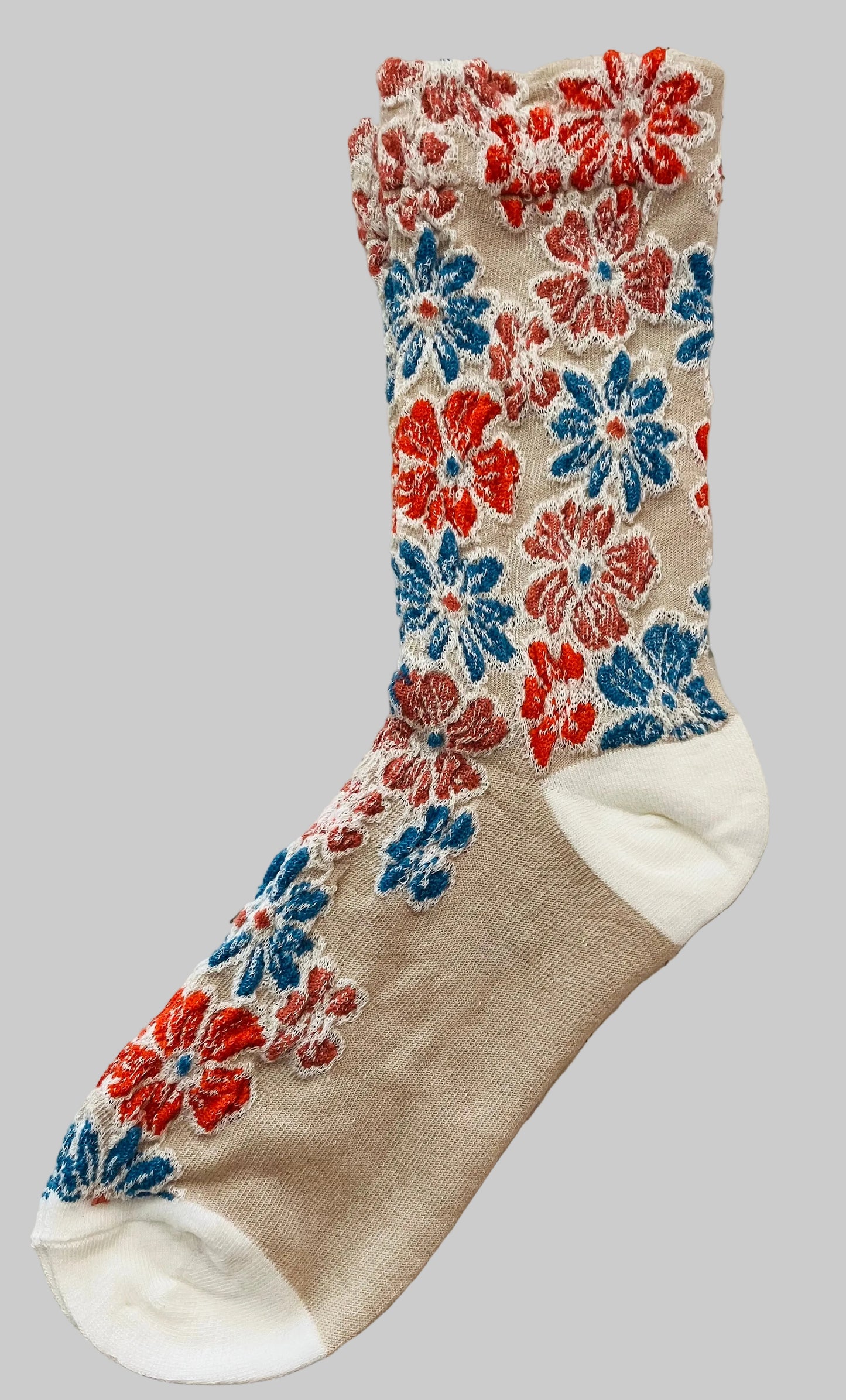 Floral-patterned sock on a textured surface